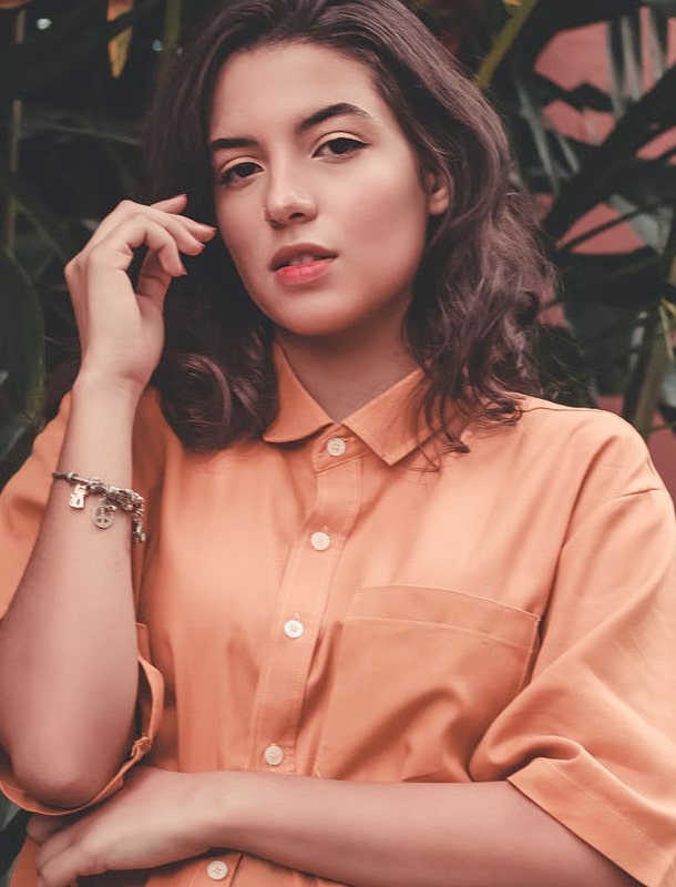 young lady in coral button down