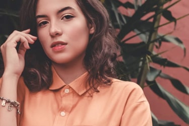 young lady in coral button down
